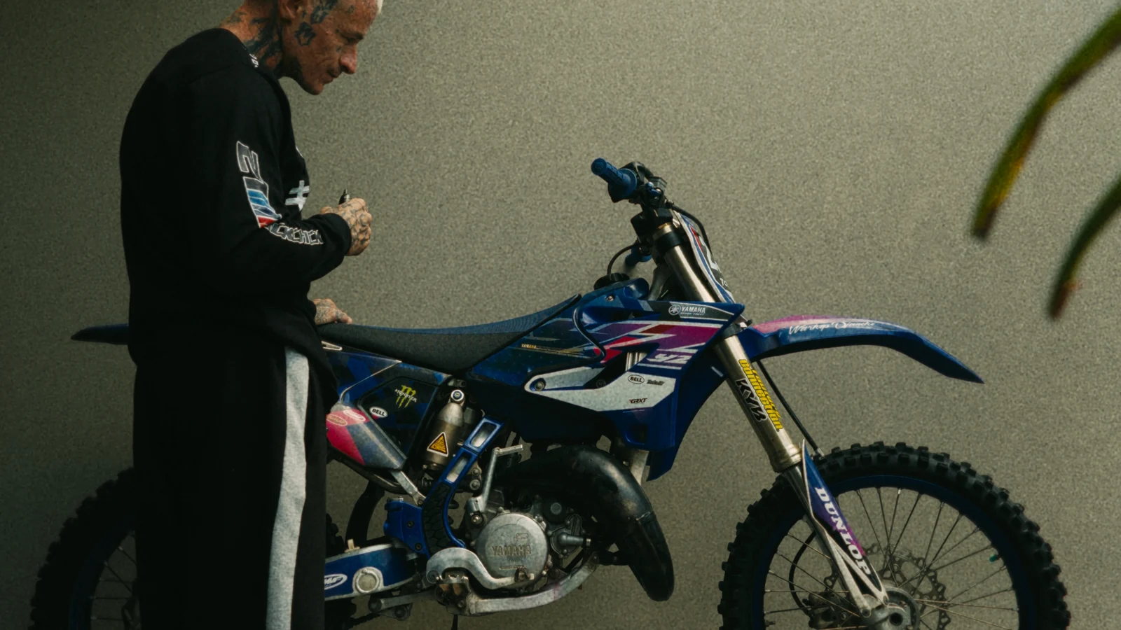 Charly beside his blue dirt bike